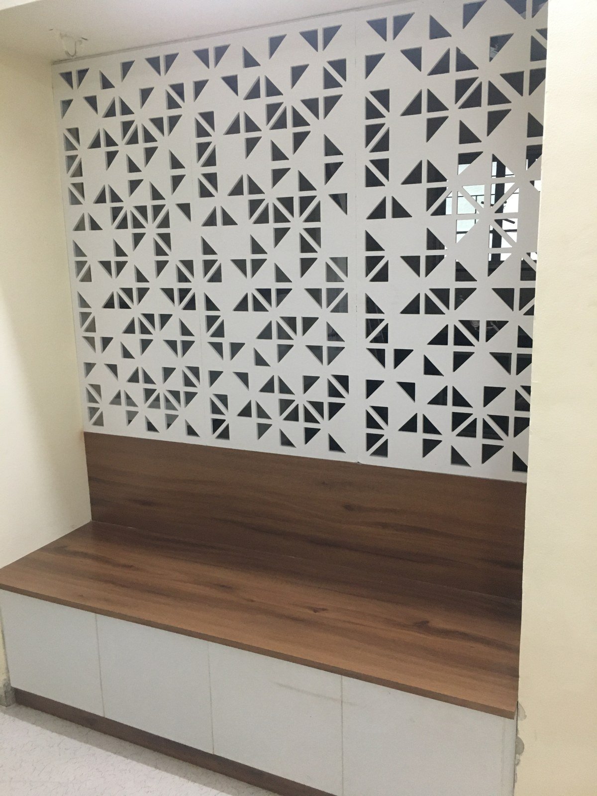 Bench seating and jaali screen in the waiting area, Pune office