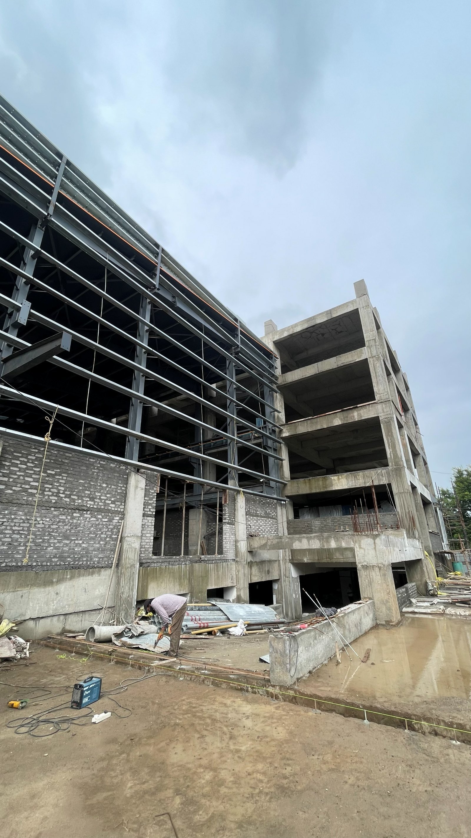 Lohia Mechatronik west elevation during construction, RCC core alongside the steel frame