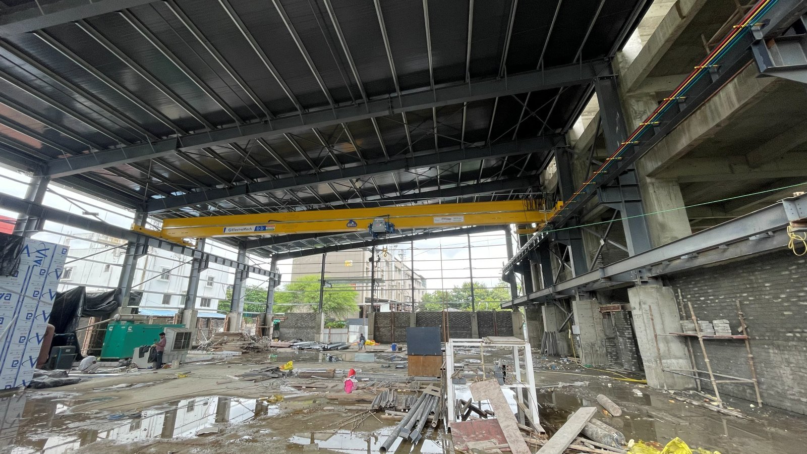 Working area beneath the erected steel roof at Lohia Mechatronik, overhead crane beam in place